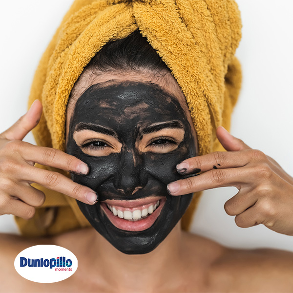 Happy Smiling Girl Applying Facial Charcoal Mask